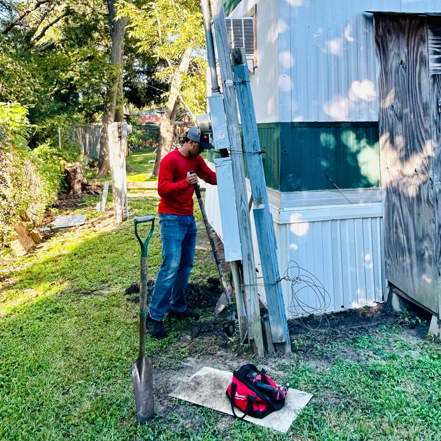 Technician servicing the exterior electrical service on a manufactured home