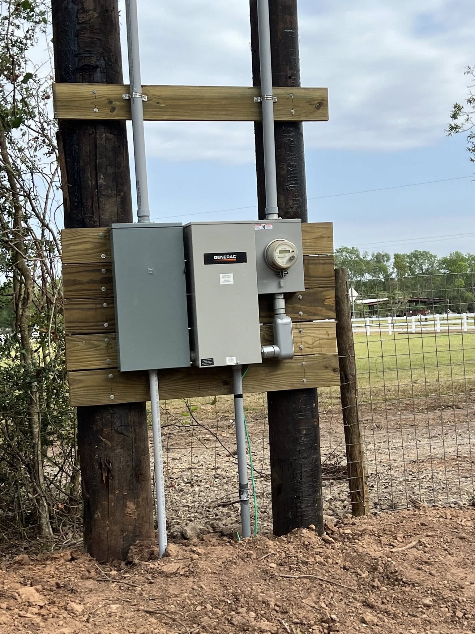 New 200-amp electrical service with a Generac automatic transfer switch installed on a ranch pole rack