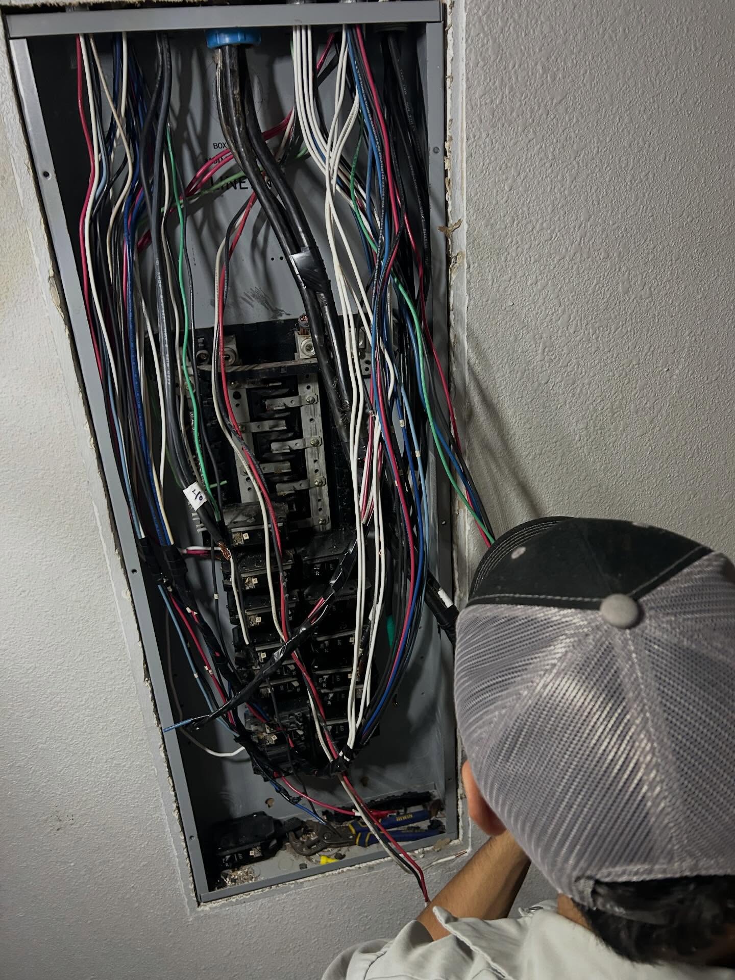 Master electrician troubleshooting a fully wired residential breaker panel