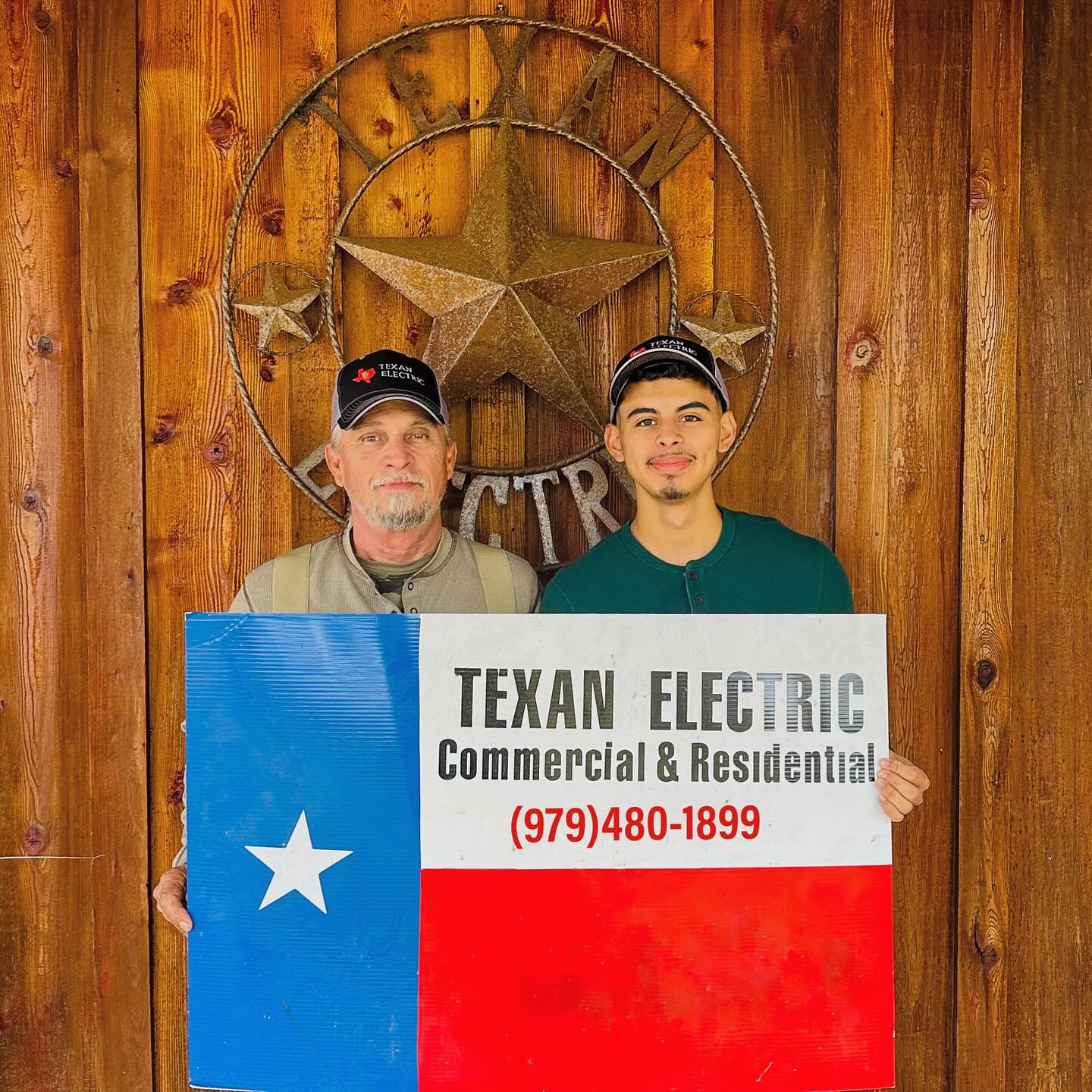 The Texan Electric team — family-owned electricians in Brazoria County, holding a Texan Electric Commercial & Residential sign in front of a Texas star