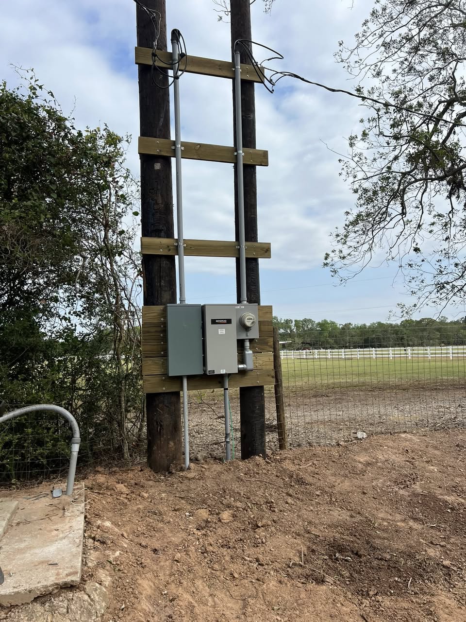 Completed electrical service upgrade neatly mounted on a rural pole rack